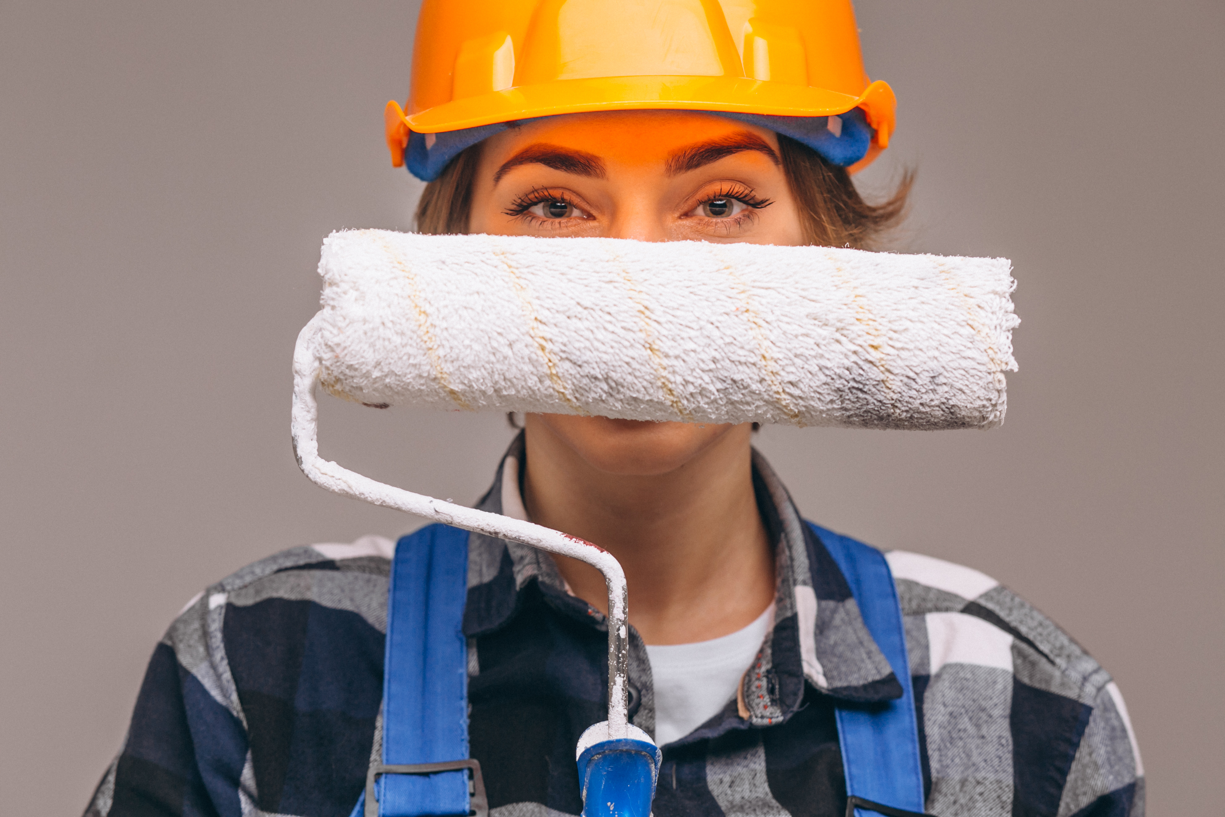 Portrait of repairer woman with painting roller isolated Portrait of repairer woman with painting roller isolated